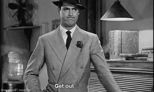 BW gif image of Cary Grant in light grey suit, white shirt, black tie, and black fedora, points emphatically and mouths the words Get out