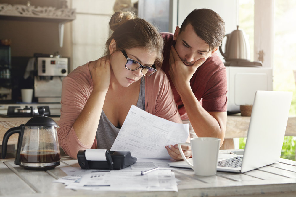 image of small business owners looking at bills